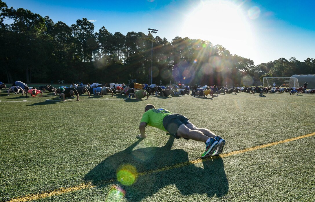 The Headquarters Air Force Special Operations Command staff performs push-ups at Hurlburt Field, Fla., May 5, 2017. These Air Commandos meet once a month to work out together. (U.S. Air Force photo/Staff Sgt. Melanie Holochwost)
