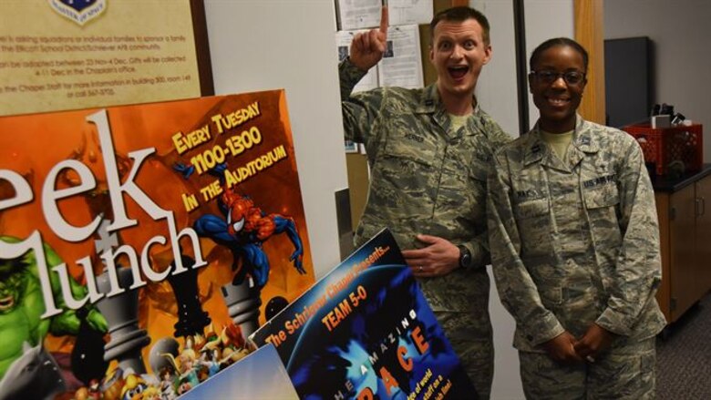 Chaplain (Capt.) Portmann Werner and Chaplain (Capt.) Jennifer Ray, 50th Space Wing Chaplain’s Office, stand by various posters promoting 50 SW Chaplain programs at Schriever Air Force Base, Colorado, Monday, March 27, 2017. The office earned numerous awards for its service at Schriever, both on the Major Command and Air Force level. (U.S. Air Force photo/Airman 1st Class William Tracy)

