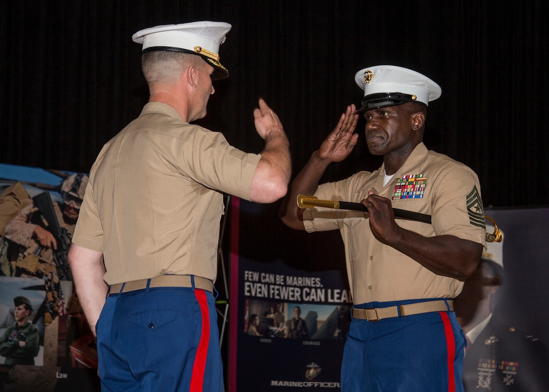 Sergeant Major Anthony N. Page, right, salutes Col. Jeffery C. Smitherman, Commanding Officer of 6th Marine Corps District (6MCD), during the 6MCD Relief and Appointment Ceremony at the base theater aboard Marine Corps Recruit Depot (MCRD) Parris Island, South Carolina, July 7, 2017. Sergeant Major Anthony N. Page was relieved by SgtMaj Cortez L. Brown after serving as the Sergeant Major of 6MCD for more than 3 years.