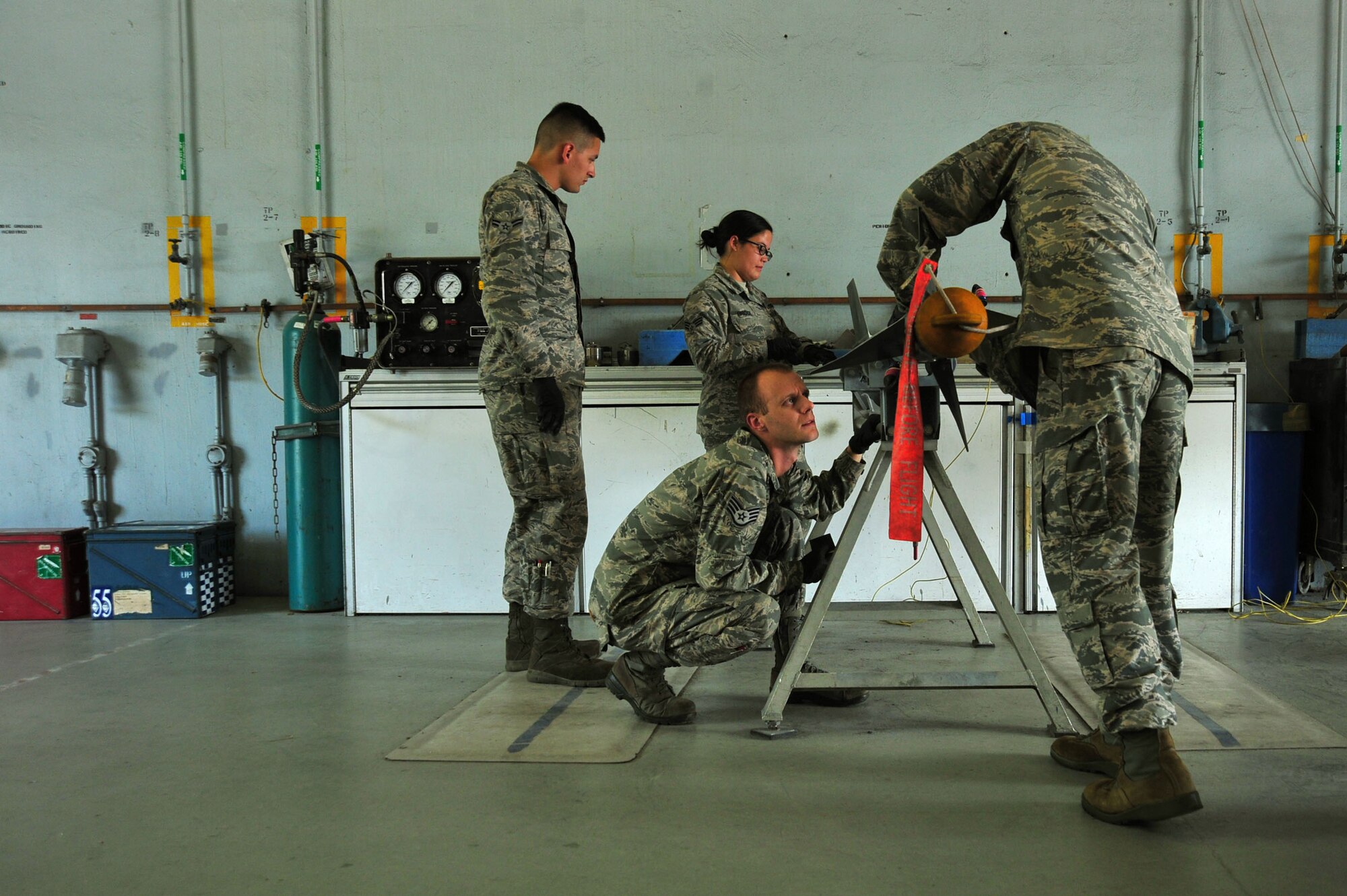 U.S. Airmen assigned to the 20th Equipment Maintenance Squadron inspect and sand rust off an AIM-9 Sidewinder missile at Shaw Air Force Base, S.C., June 27, 2017. The Airmen inspected the munition to locate scratches, dents and rust which may compromise its integrity. (U.S. Air Force photo by Airman 1st Class Kathryn R.C. Reaves)