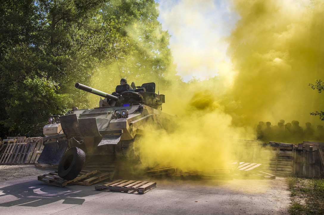 Soldiers breach a barricade with an M113 vehicle during a riot control training scenario as part of a mission rehearsal exercise at the Joint Multinational Readiness Center in Hohenfels, Germany, July 6, 2017. Army photo by Spc. Randy Wren