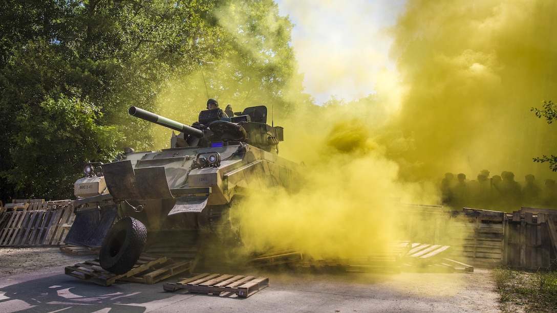 Soldiers breach a barricade with an M113 vehicle during a riot control training scenario as part of a mission rehearsal exercise at the Joint Multinational Readiness Center in Hohenfels, Germany, July 6, 2017. Army photo by Spc. Randy Wren