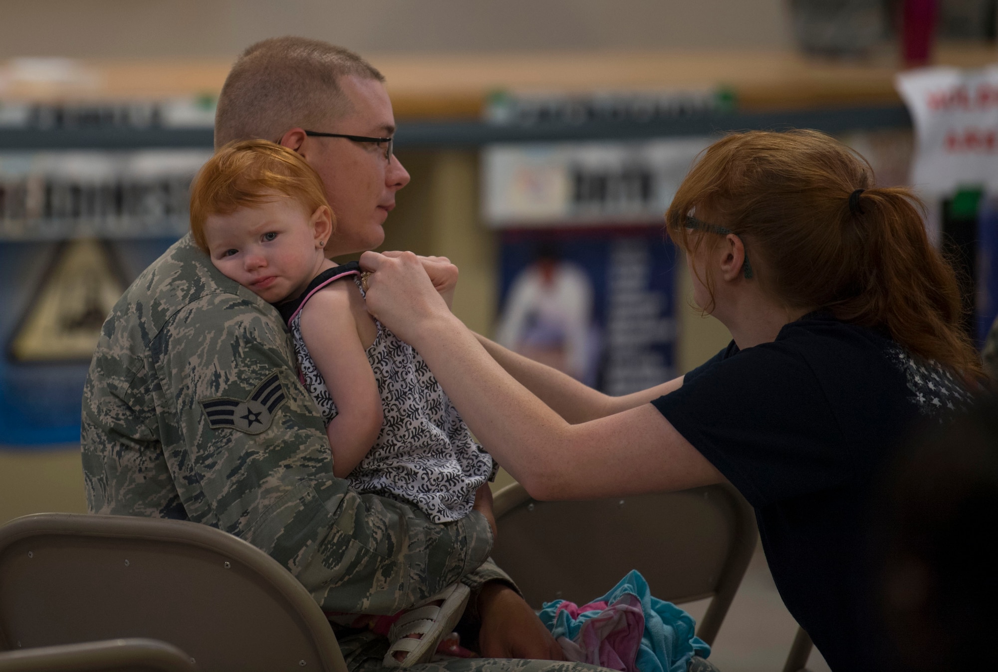 Senior Airman Justin Mullens holds his daughter, Elaina, while his wife looks on, prior to deploying in support of Operation Freedom Sentinel on June 25, 2017 prior to departing McLaughlin Air National Guard base for a deployment in support of Operation Freedom’s Sentinel on June 25, 2017. Mullens is an aircraft structural maintainer with the 130th Airlift Wing. (U.S. Air National Guard photo by Tech. Sgt. De-Juan Haley)