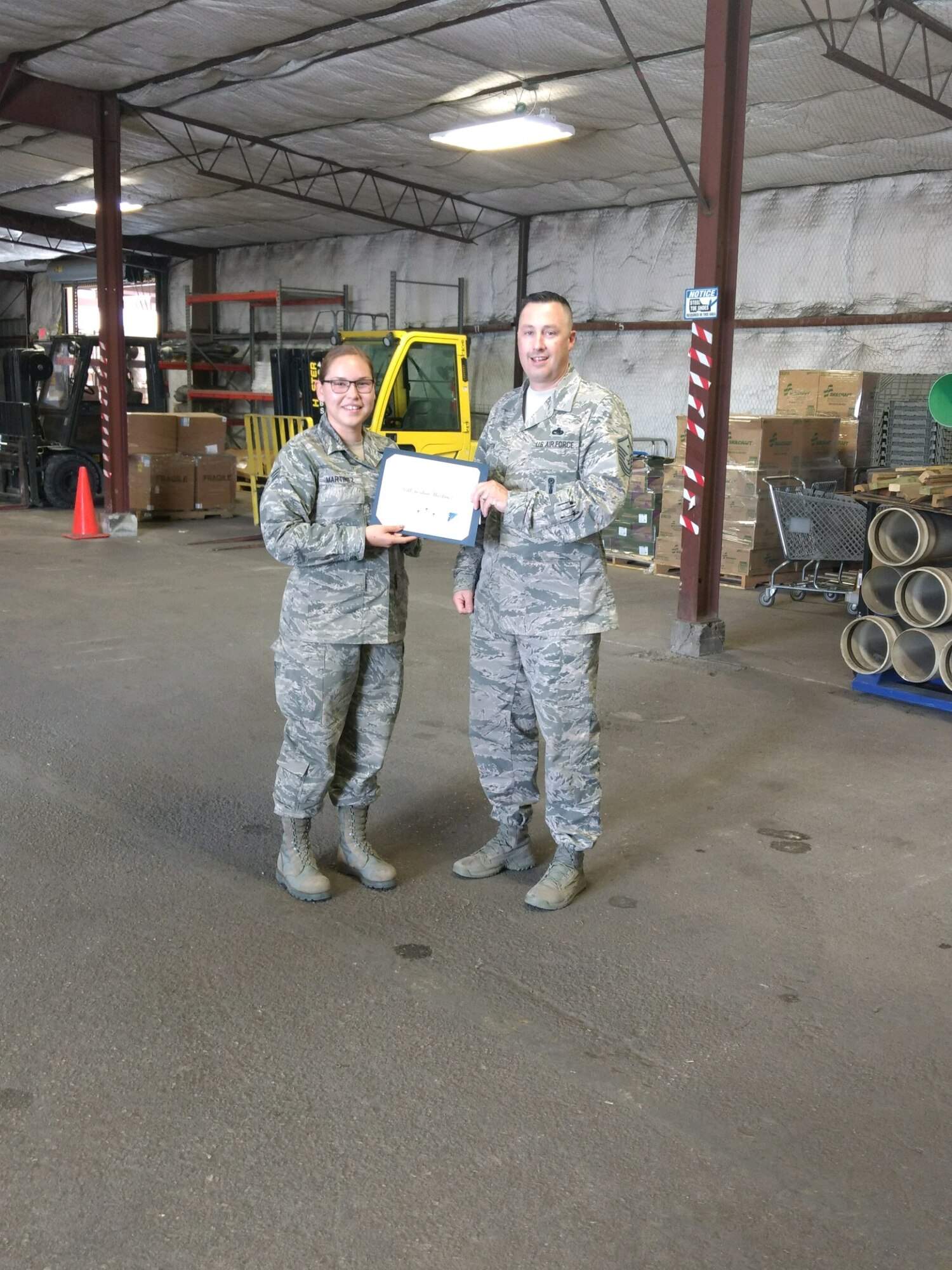 Senior Airman Jordan Martinez, 49th Civil Engineer Squadron operations management journeyman, is presented the Top III Airman award for May from Master Sgt. Timothy Gatten, 54th AMXS first sergeant and Top III president, at Holloman Air Force Base, N.M., June 29, 2017. Martinez’s work involved managing four military members and four civilians, overseeing a $2.3 million budget, and eight warehouses containing $17 million worth of materials. On top of filling in as the non-commissioned officer in charge she also filled the chief of material control position. She coordinated 288 purchase request items valued at $525K with 250 vendors driving work production for 11 civil engineer work centers. (Courtesy photo)