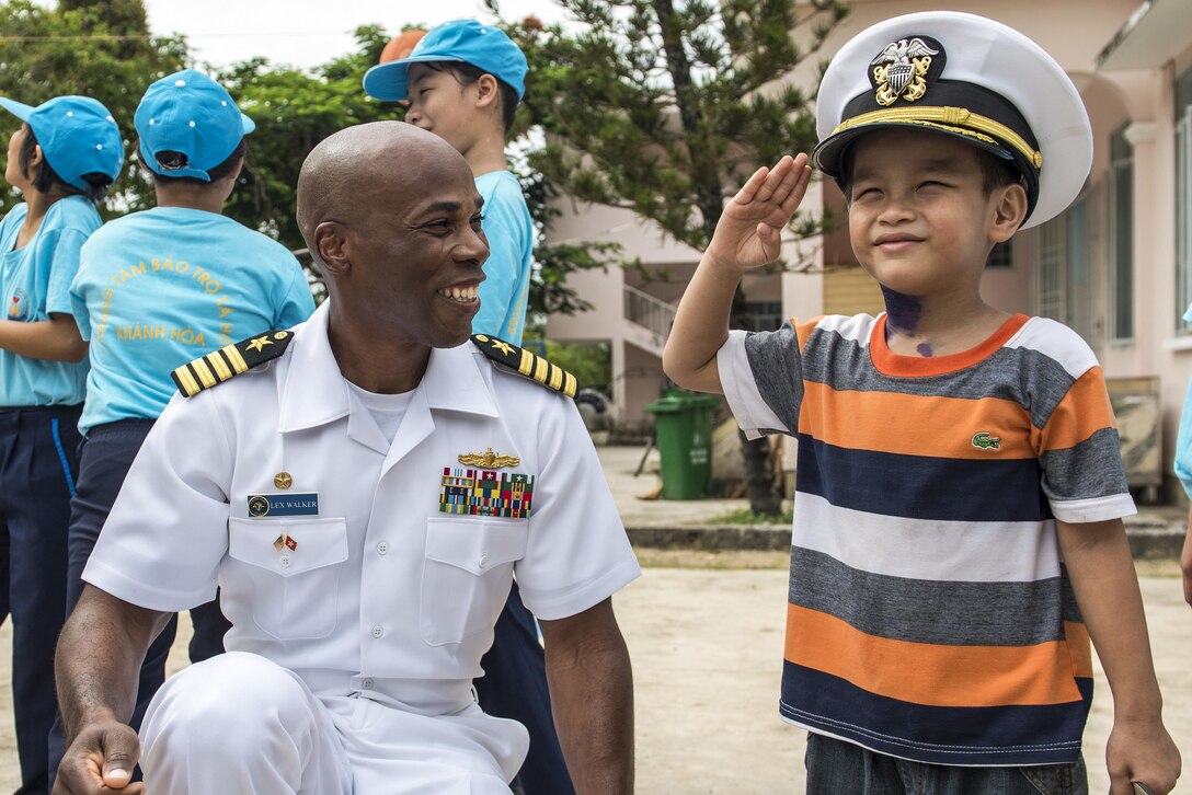 Navy Capt. Lex Walker spends time with a resident of Khanh Hoa Center for Social Protection in Nha Trang, Vietnam, July 6, 2017, during Naval Engagement Activity Vietnam 2017. Walker is commodore of Destroyer Squadron 7. The engagement provides an opportunity for U.S. and Vietnamese sailors to enhance mutual capabilities and strengthen partnerships with the community. Navy photo by Petty Officer 2nd Class Joshua Fulton