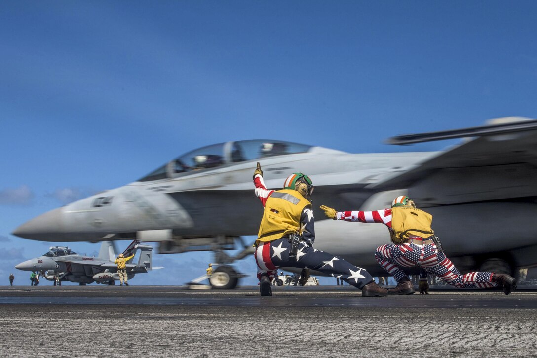 Navy Lts. Miranda Krasselt and Chris Williams signal for the launch of an F/A-18F Super Hornet on the flight deck of the aircraft carrier USS Ronald Reagan in the Pacific Ocean, July 4, 2017. The Ronald Reagan is on patrol in the U.S. 7th Fleet area of responsibility to support security and stability in the Indo-Asia-Pacific region. Navy photo by Petty Officer 2nd Class Kenneth Abbate
