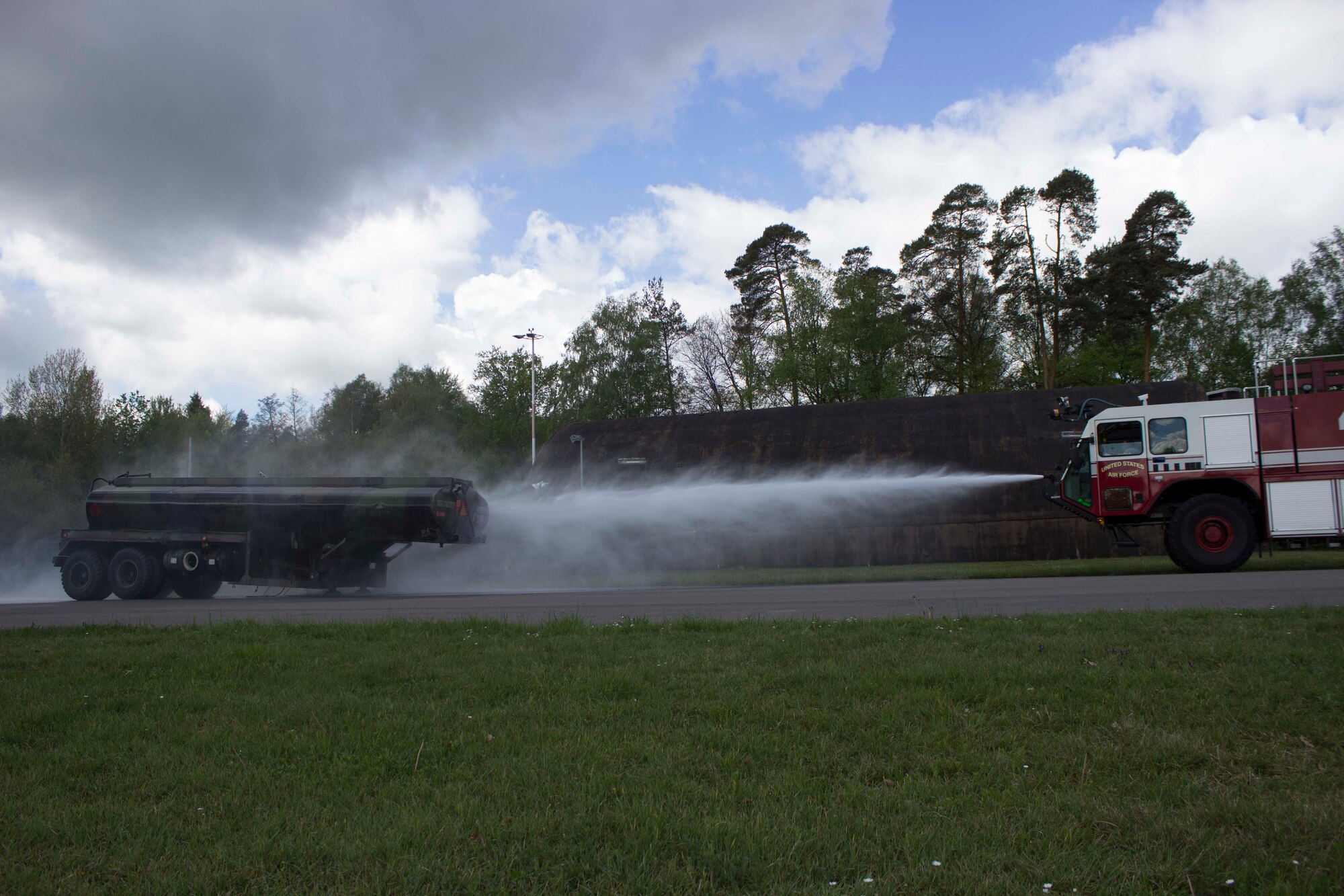 Fire emergency services personnel at Ramstein Air Base, Germany, put out a mock fuel tanker fire during recent Silver Flag instruction at the base. Preparing for this type of event ensures Airmen are better prepared should wartime events occur.  (U.S. Air Force Photo/Susan H. Lawson)
