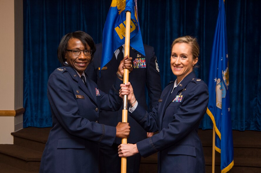 Col. Cherron Galluzzo, 90th Medical Group commander, passes the guidon to Lt. Col. Lindsey Oleson, 90th Medical Support Squadron commander, during the 90th MDSS change of command ceremony at F.E. Warren Air Force Base, Wyo., July 7, 2017. The ceremony signified the transition of command from Lt. Col. Tim Christison. (U.S. Air Force photo by Staff Sgt. Christopher Ruano)