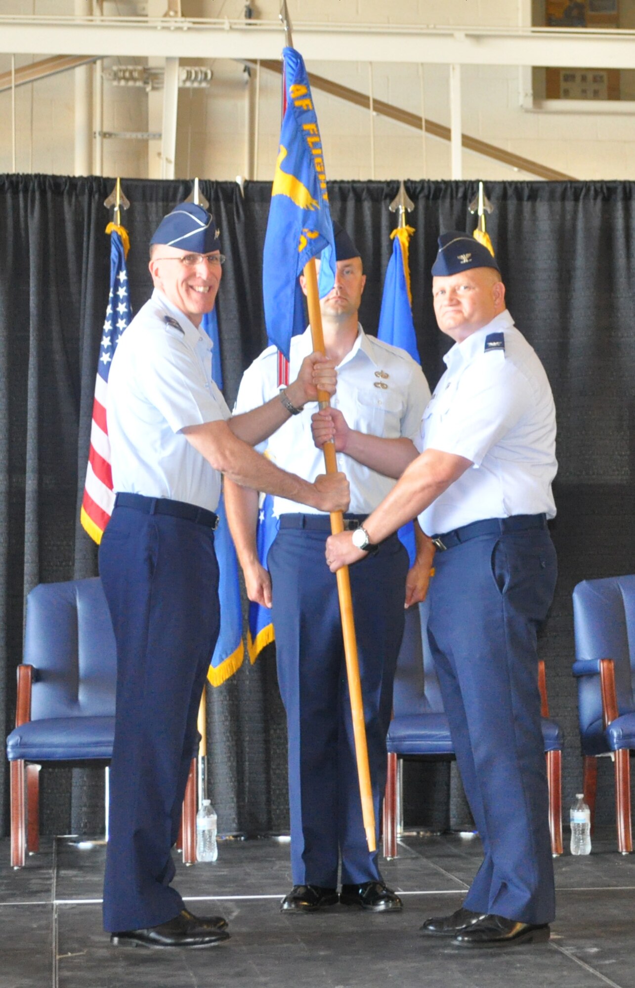 Major Gen. Scott Vander Hamm, assistant deputy chief of staff, operations, Air Force Headquarters, left, hands the guidon to Col. Michael J. Price during a change of command ceremony June 22 at the Will Rogers Air National Guard Base. The colonel took the reins of the approximately 200-member Air Force Flight Standards Agency. Master Sgt. Jeremy Sykora was the guidon bearer. (Air Force photo by John Parker)