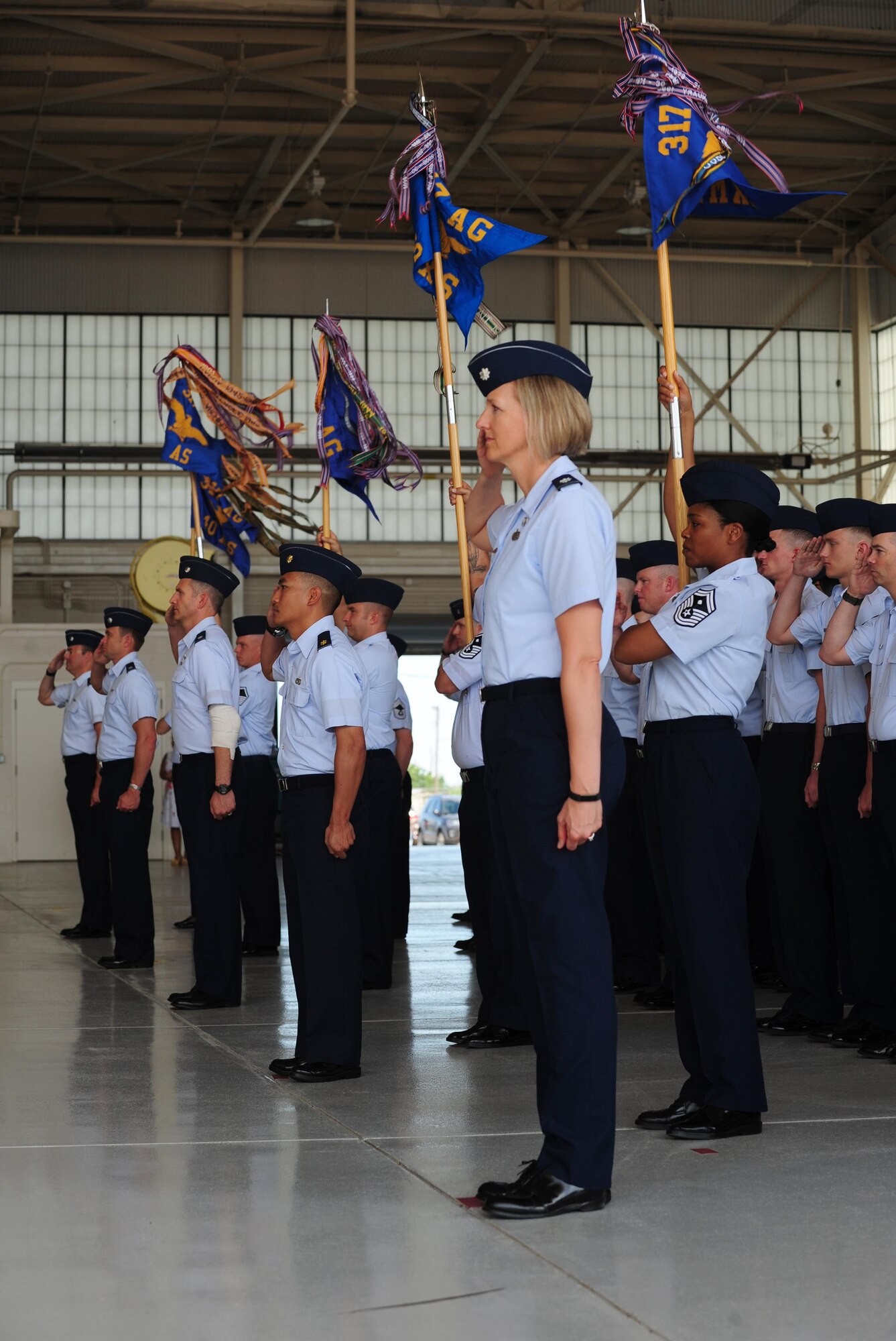U.S. Air Force Airmen from the 317th Airlift Wing render a salute during the 317th AW activation ceremony at Dyess Air Force Base, Texas, July 6, 2017. The 317th AW supports the Department of Defense, Joint Chiefs of Staff and higher headquarter taskings, and reports to the 18th Air Force at Scott AFB, Ill. (U.S. Air Force photo by Airman 1st Class April Lancto)