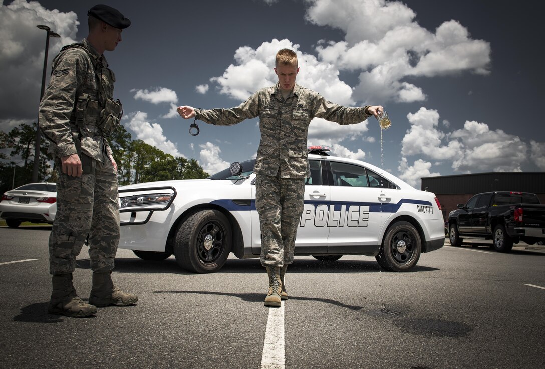 Airman 1st Class Erick Requadt, 23d Wing photojournalist, simulates a field sobriety test, July 7, 2017, at Moody Air Force Base, Ga. When an Airman receives a driving under the influence charge, they are eligible to receive both a civilian conviction if caught off base, as well as a punishment given at their commander’s discretion. The final sentence could cost thousands of dollars in fines, suspension of their license, negative paperwork, administrative demotion, and possible loss of career or reclassification. (U.S. Air Force photo illustration by Airman 1st Class Lauren M. Sprunk)