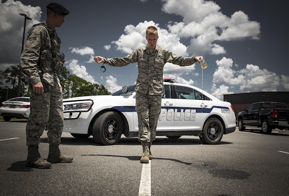 Airman 1st Class Erick Requadt, 23d Wing photojournalist, simulates a field sobriety test, July 7, 2017, at Moody Air Force Base, Ga. When an Airman receives a driving under the influence charge, they are eligible to receive both a civilian conviction if caught off base, as well as a punishment given at their commander’s discretion. The final sentence could cost thousands of dollars in fines, suspension of their license, negative paperwork, administrative demotion, and possible loss of career or reclassification. (U.S. Air Force photo illustration by Airman 1st Class Lauren M. Sprunk)