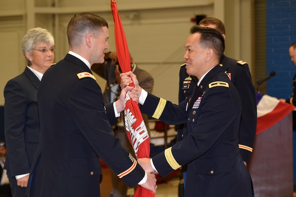 Brig. Gen. Mark Toy (Right), U.S. Army Corps of Engineers Great Lakes and Ohio River Division commander, passes the Corps of Engineers flag to Lt. Col. Cullen A. Jones as he took command of the Nashville District during a change of command ceremony July 7, 2017 at the Tennessee National Guard Armory in Nashville, Tenn.