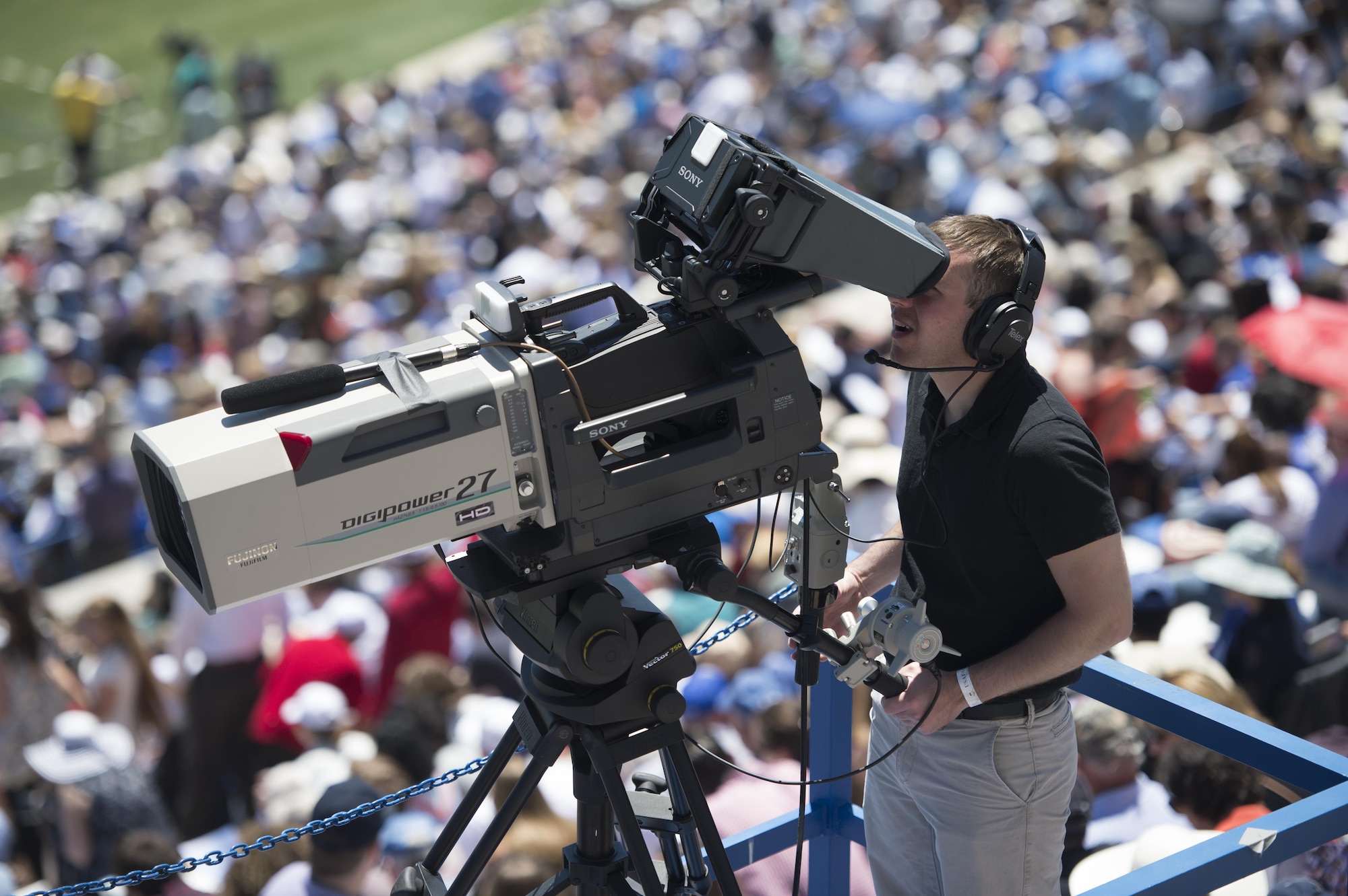 Airman 1st Class Frederick Brown operates a Sony HD camera with Fujinon Sports lens during live broadcast of Air Force Academy Graduation, May 24, 2017. (U.S. Air Fore photo by Staff Sgt. Andrew Lee)