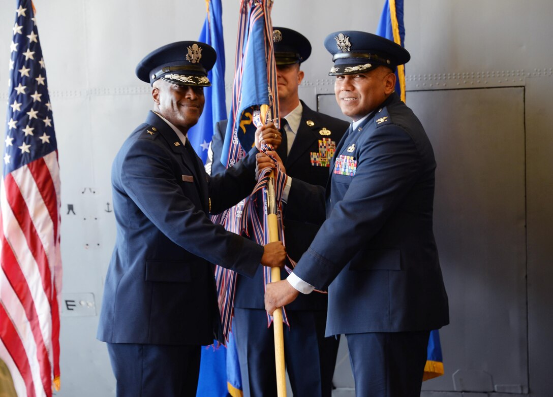 Brig. Gen. Ronald E. Jolly Sr., 82nd Training Wing commander, passes the ceremonial guidon to Col. Anthony Puente, incoming 982nd Training Group commander, during the 982nd TRG Change of Command ceremony at Sheppard Air Force Base, Texas, July 7, 2017.