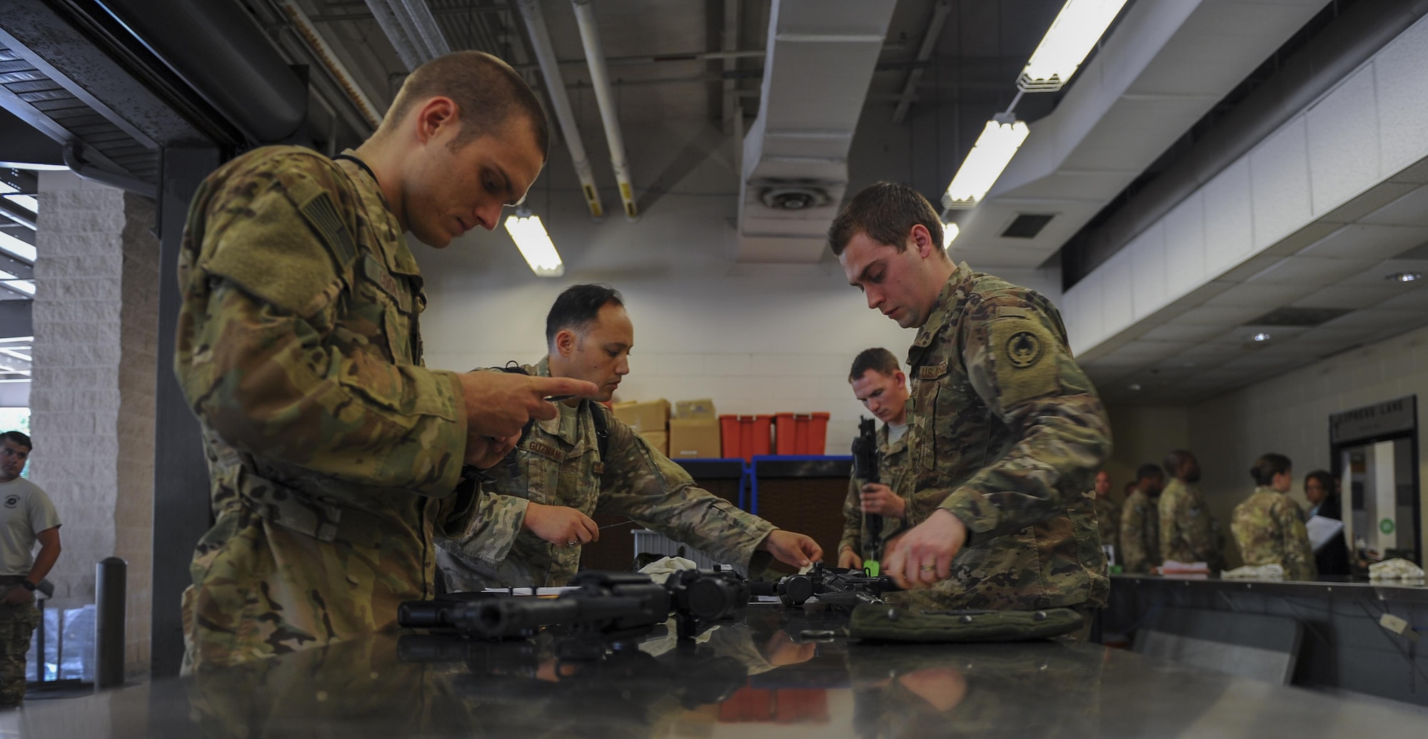 Air Commandos clean their weapon during post-deployment in-processing at the deployment control center, Hurlburt Field, Fla., July 6, 2017. Air Commandos clean weapons for a final time before returning them to the 1st Special Operations Squadron Combat Arms Training and Maintenance. Incorporating feedback from Air Commandos, the DCC added CATM in October 2016 to alleviate the need to make an additional stop after reintegration. (U.S. Air Force photo by Airman 1st Class Isaac O. Guest IV)