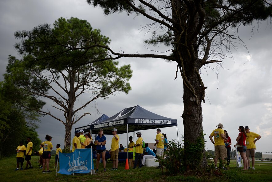 Volunteers plan for their roles during inclement weather before Fireworks on the Water begins July 1, 2017, at the Stennis Lock and Dam in Columbus, Mississippi. Numerous volunteers helped hold down various tents and other items through the harsh wind and rain.