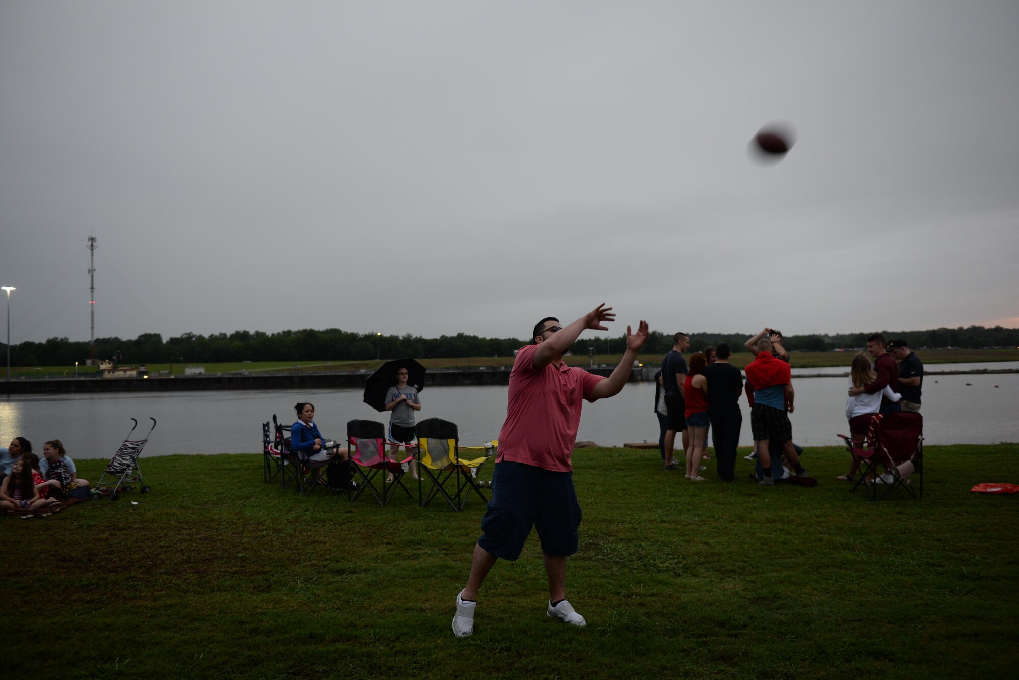 Dr. Medhat Hamed, a new Columbus, Mississippi, resident, catches a football during Fireworks on the Water July 1, 2017, at the Stennis Lock and Dam in Columbus. Many people created their own entertainment because the scheduled live music was unable to take place in the rain. 