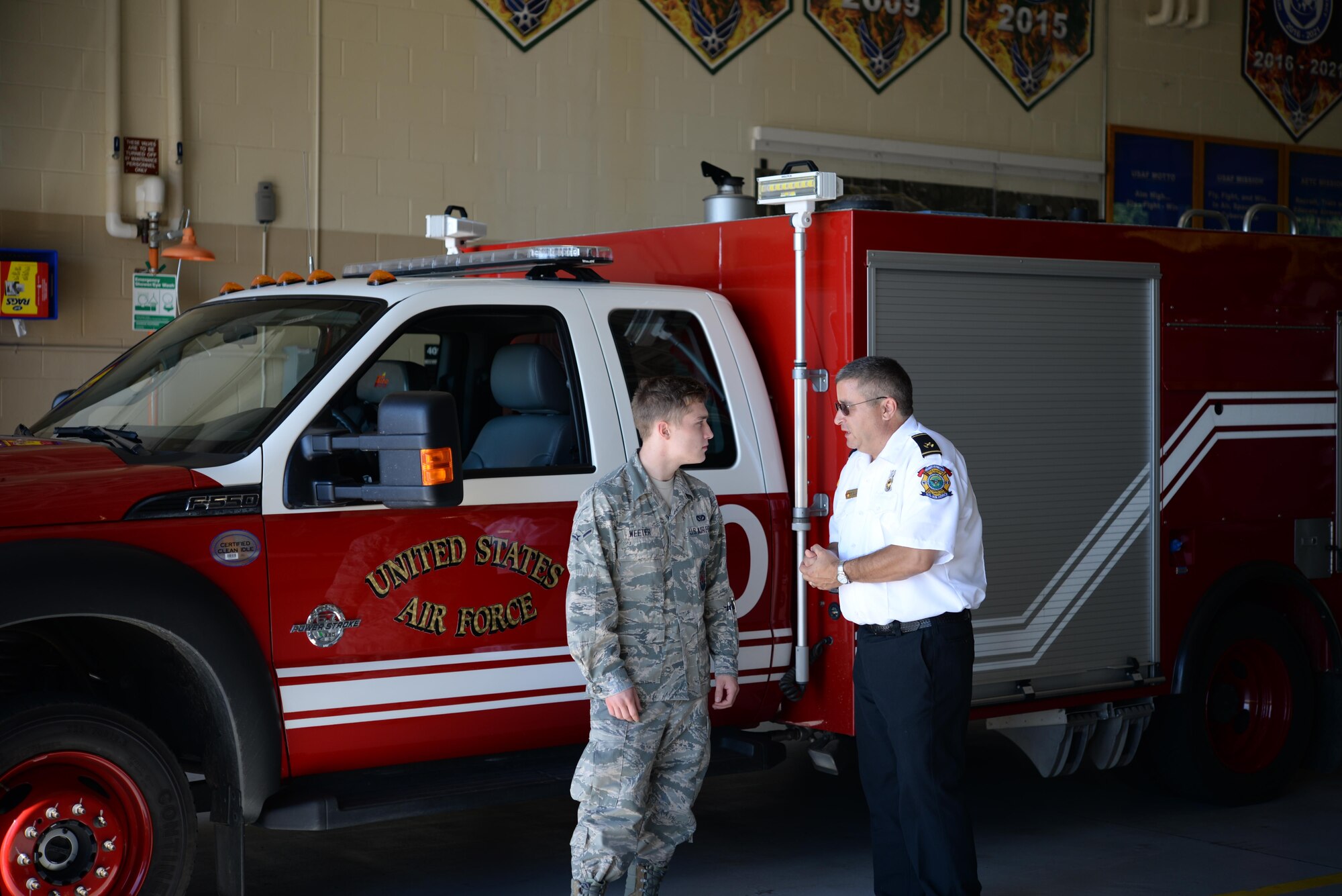 Airman Justin Weeter, 14th Civil Engineer Squadron firefighter, and Peter Delillo, 14th CES Fire Prevention Inspector, talk inside the Columbus Air Force Base, Mississippi, Fire Station June 29, 2017. The Fire Protectors have many different ways to bring information to the Airmen and families on base through community events and different courses mandatory to newly arriving base members. (U.S. Air Force photo by Airman 1st Class Keith Holcomb)