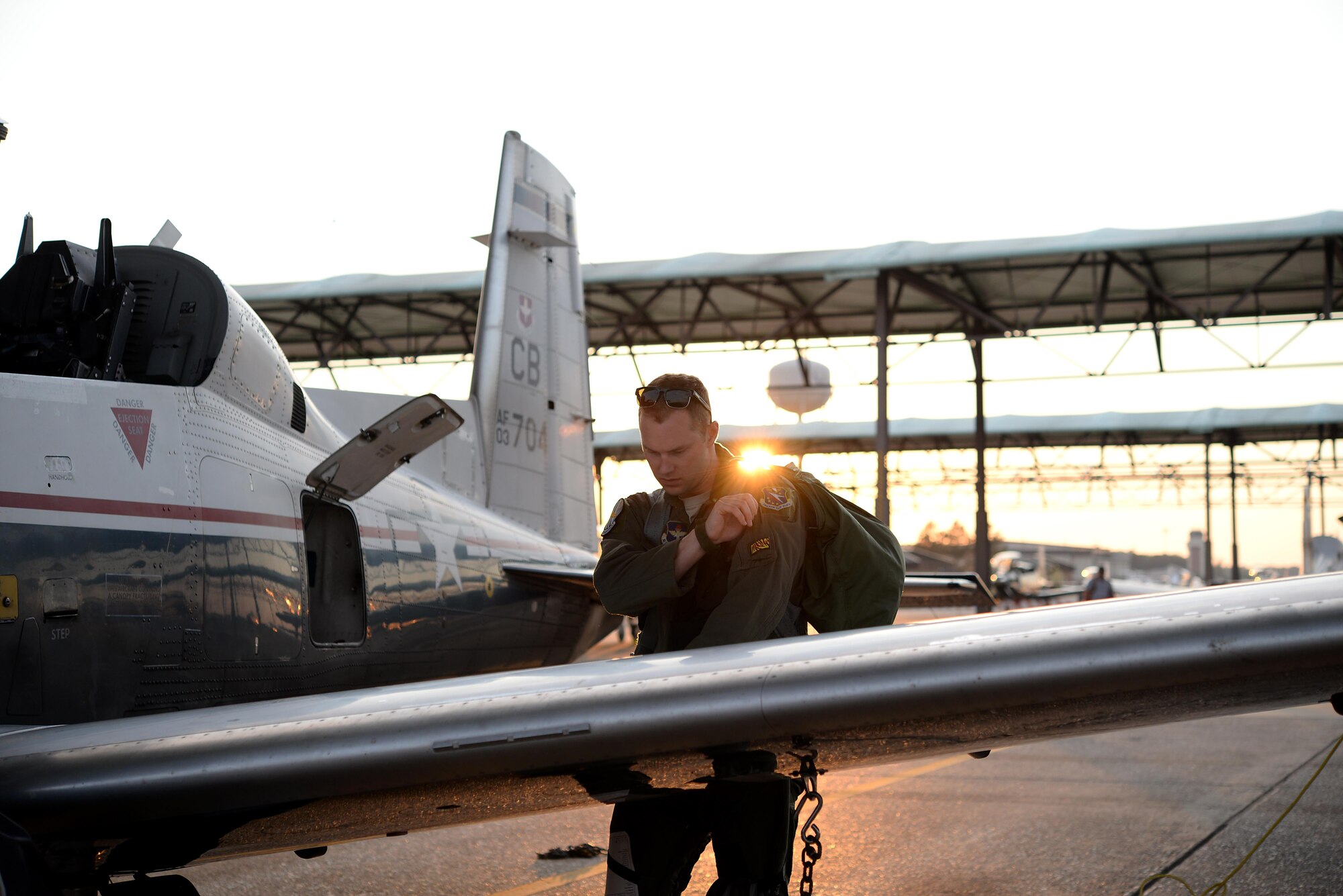 Capt. Roland Neal, 37th Flying Training Squadron Instructor Pilot, grabs his gear after a flight June 28, 2017, on Columbus Air Force Base, Mississippi. The instructor pilots ride with student pilots unless the student is taking a solo flight. (U.S. Air Force photo by Airman 1st Class Keith Holcomb)