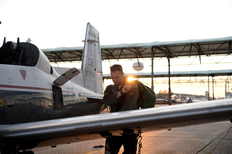 Capt. Roland Neal, 37th Flying Training Squadron Instructor Pilot, grabs his gear after a flight June 28, 2017, on Columbus Air Force Base, Mississippi. The instructor pilots ride with student pilots unless the student is taking a solo flight. (U.S. Air Force photo by Airman 1st Class Keith Holcomb)