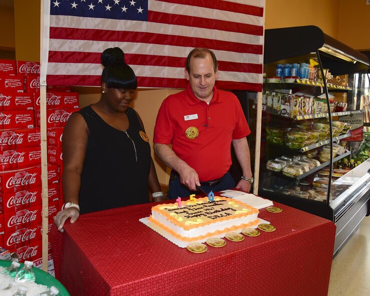Tanesha Hill, Columbus Air Force Base Commissary Interim Secretary, and Greg Runyon, Columbus AFB Commissary Assistant Store Director, cut a cake at the Columbus AFB Commissary June 30, 2017, on Columbus AFB, Mississippi. The event was in recognition of the Defense Commissary Agency’s 150 years of service to the Armed Forces. (U.S. Air Force photo by Elizabeth Owens)