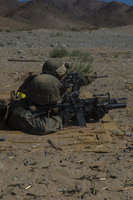 TWENTYNINE PALMS, Calif. – Cpl.  Travis Eastin (left) and Cpl. Joseph Bradley (right), both riflemen for Echo Company, 2nd Battalion, 24th Marine Regiment, 4th Marine Division, Marine Forces Reserve fire at pop-up targets at Range 410A during Integrated Training Exercise 4-17 at Marines Corps Air Ground Combat Center,  Twentynine Palms, California on June 26, 2017. ITX 4-17 is a combined arms exercise that trains Marines in such a way that they can seamlessly integrate with active duty Marines into a Marine Air Ground Task Force.