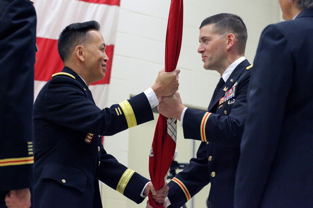 Brig. Gen. Mark Toy (Right), U.S. Army Corps of Engineers Great Lakes and Ohio River Division commander, passes the Corps of Engineers flag to Lt. Col. Cullen A. Jones as he took command of the Nashville District during a change of command ceremony July 7, 2017 at the Tennessee National Guard Armory in Nashville, Tenn. 