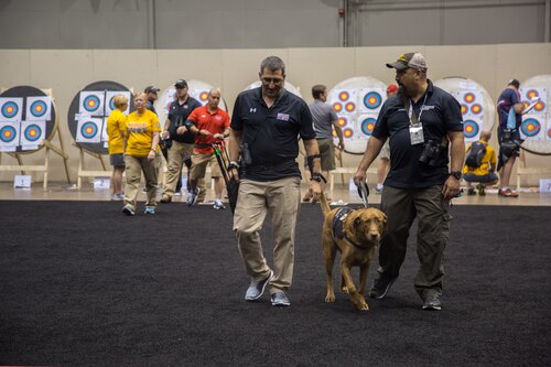 U.S. Army Col. Michael Malone, from Bethesda, Md., conversates with Coach Frank Barroqueiro during the archery competition for the 2017 Department of Defense Warrior Games at Chicago, Ill., July 3, 2017. The DOD Warrior Games are an annual event allowing wounded, ill and injured service members and veterans in Paralympic-style sports including archery, cycling, field, shooting, sitting volleyball, swimming, track and wheelchair basketball. (U.S. Army photo by Pfc. Genesis Gomez)