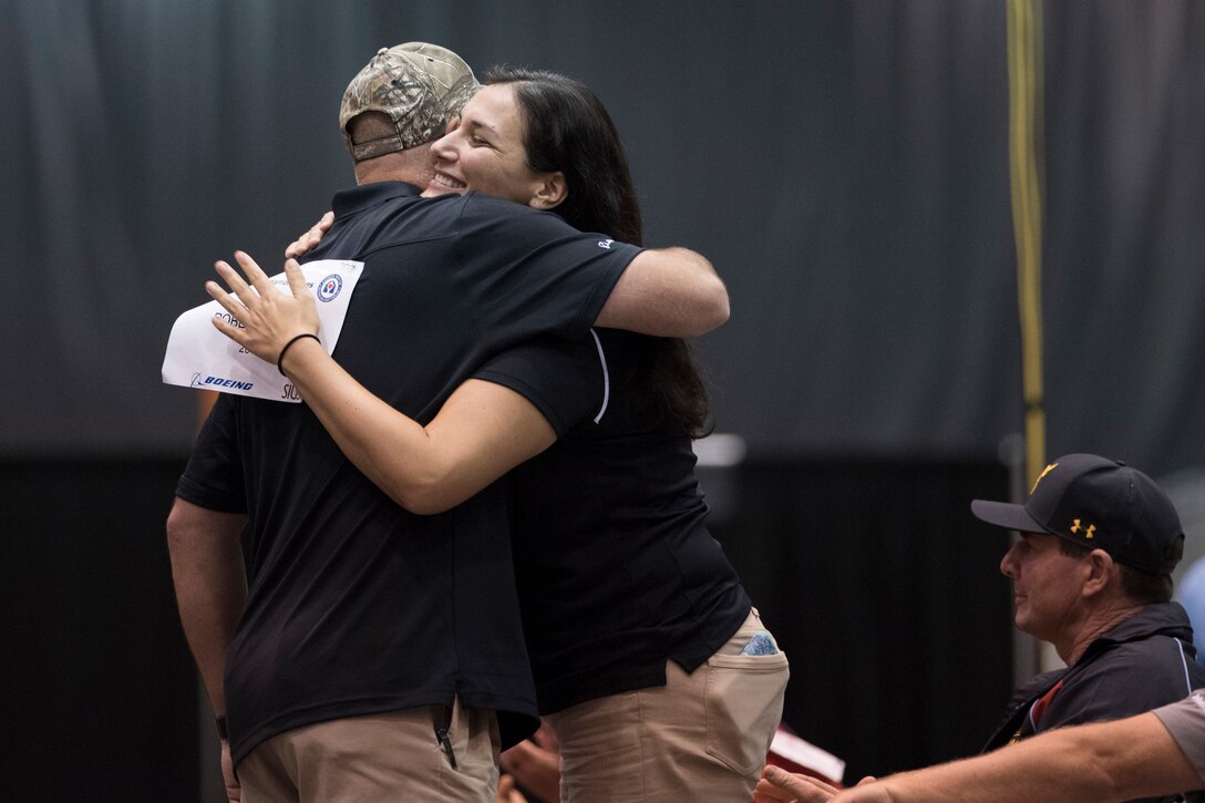 Army veteran Robert Roberts hugs his coach Navy veteran Laura Root, who is a former gold medal winner in shooting in the Warrior Games, after Roberts competed in air pistol finals during the 2017 Department of Defense (DoD) Warrior Games in Chicago, Ill., July 6, 2017. The DoD Warrior Games are an annual event allowing wounded, ill and injured service members and veterans to compete in Paralympic-style sports including archery, cycling, field, shooting, sitting volleyball, swimming, track and wheelchair basketball.    (DoD photo by Roger L. Wollenberg)