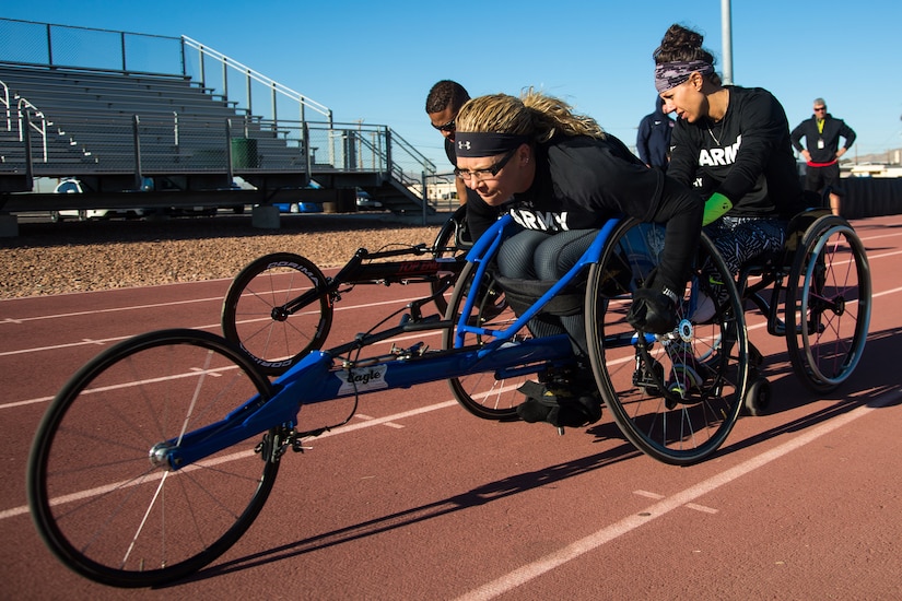 U.S. Army veteran, Brandi Evans, works with U.S. Army Capt. Kelly Elmlinger, a previous Team Army athlete returning as a mentor, does resistance starts for maximizing take off speed on the racing wheelchair for the Warrior Care and Transition's Army Trials at Fort Bliss Texas, March 30, 2017. About 80 wounded, ill and injured active-duty Soldiers and veterans are competing in eight different sports 2-6 April for the opportunity to represent Team Army at the 2017 Department of Defense Warrior Games. (U.S. Army photo by Spc. Fransico Isreal)