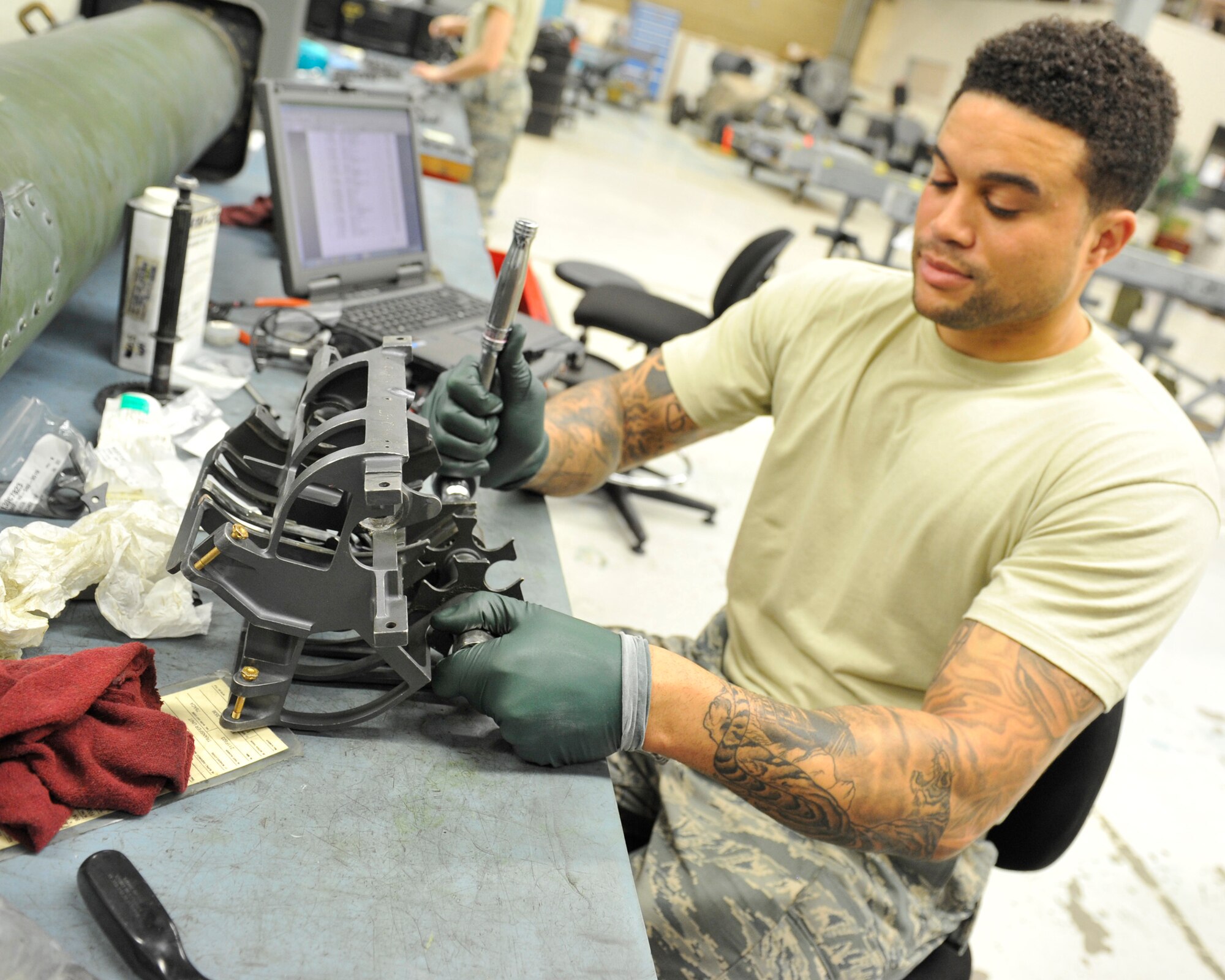 Staff Sgt. Jacorey Burbank, 56th Equipment Maintenance Squadron armament flight supervisor, completes the reassembly of an M61A1 gun transfer unit June 28, 2017 at Luke Air Force Base, Ariz. The Transfer unit transfers the rounds from the handling system to the gun system. (U.S. Air Force photo by Airman 1st Class Pedro Mota)