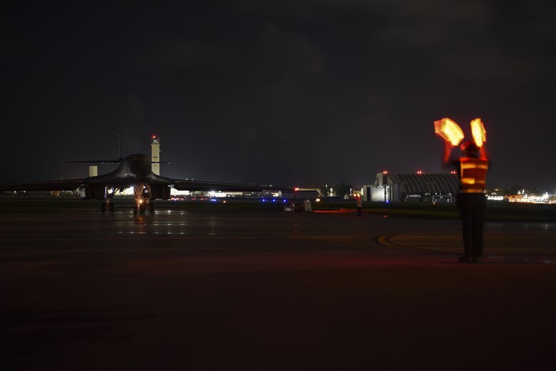 A U.S. Air Force B-1B Lancer assigned to the 9th Expeditionary Bomb Squadron, deployed from Dyess Air Force Base, Texas, is marshalled onto a runway at Andersen Air Force Base, Guam to conduct a sequenced bilateral mission with South Korean F-15 and Koku Jieitai (Japan Air Self-Defense Force) F-2 fighter jets, July 7. The mission is in response to a series of increasingly escalatory action by North Korea, including a launch of an intercontinental ballistic missile (ICBM) on July 3. (U.S. Air Force Photo by Tech. Sgt. Richard P. Ebensberger)