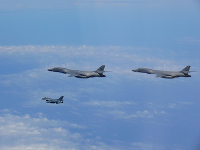 Two U.S. Air Force B-1B Lancers assigned to the 9th Expeditionary Bomb Squadron, deployed from Dyess Air Force Base, Texas, fly with a Koku Jieitai (Japan Air Self-Defense Force) F-2 fighter jet over the East China Sea, July 7. The Lancers departed Andersen Air Force Base, Guam to conduct a sequenced bilateral mission with South Korean F-15 and Koku Jieitai (Japan Air Self-Defense Force) F-2 fighter jets. The mission is in response to a series of increasingly escalatory action by North Korea, including a launch of an intercontinental ballistic missile (ICBM) on July 3. (photo courtesy of Japan Air Self-Defense Force)