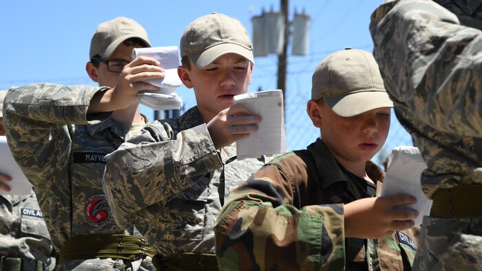 Civil Air Patrol cadets review their “smart books” while standing in line during the Desert Hawk XV encampment, Historic Wendover Airfield, Utah. (U.S. Air Force photo/R. Nial Bradshaw)