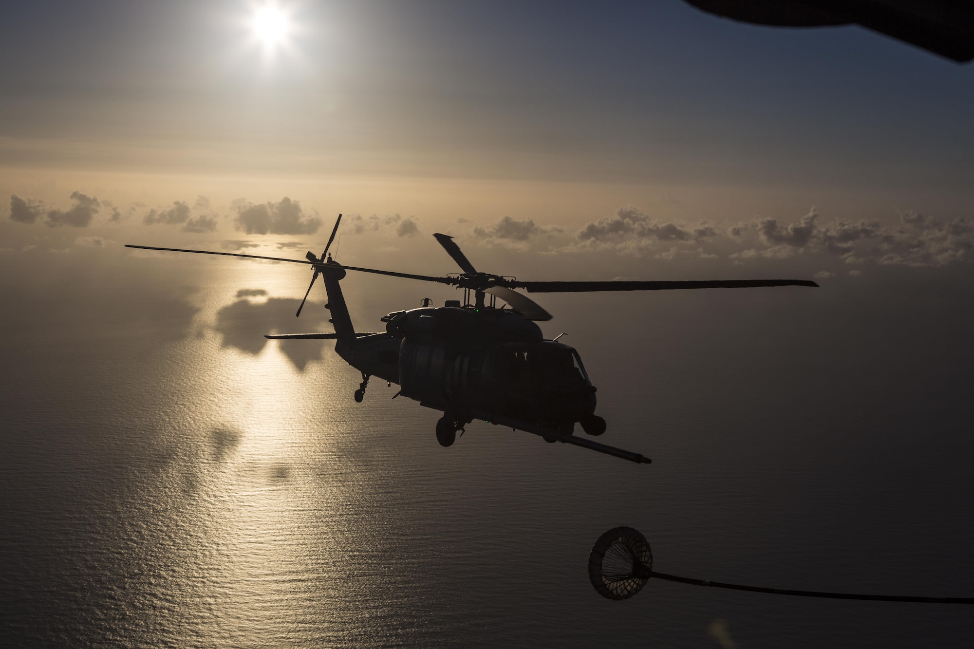 An HH-60G Pave Hawk refuels from an HC-130P/N King enroute to rescue two German citizens in distress at sea July 7, 2017 and into July 8. The victim's vessel caught fire approximately 500 nautical miles off the east coast of southern Florida. At the request of the U.S. Coast Guard's Seventh District in Miami, the 920th RQW was alerted by the Air Force Rescue Coordination Center at Tyndall Air Force Base, Florida, to assist in the long-range search and rescue. Approximately 80 wing Citizen Airmen and four wing aircraft helped execute the rescue mission to include, maintenance, operations and support personnel. (U.S. Air Force photo by Master Sgt. Mark Borosch)
