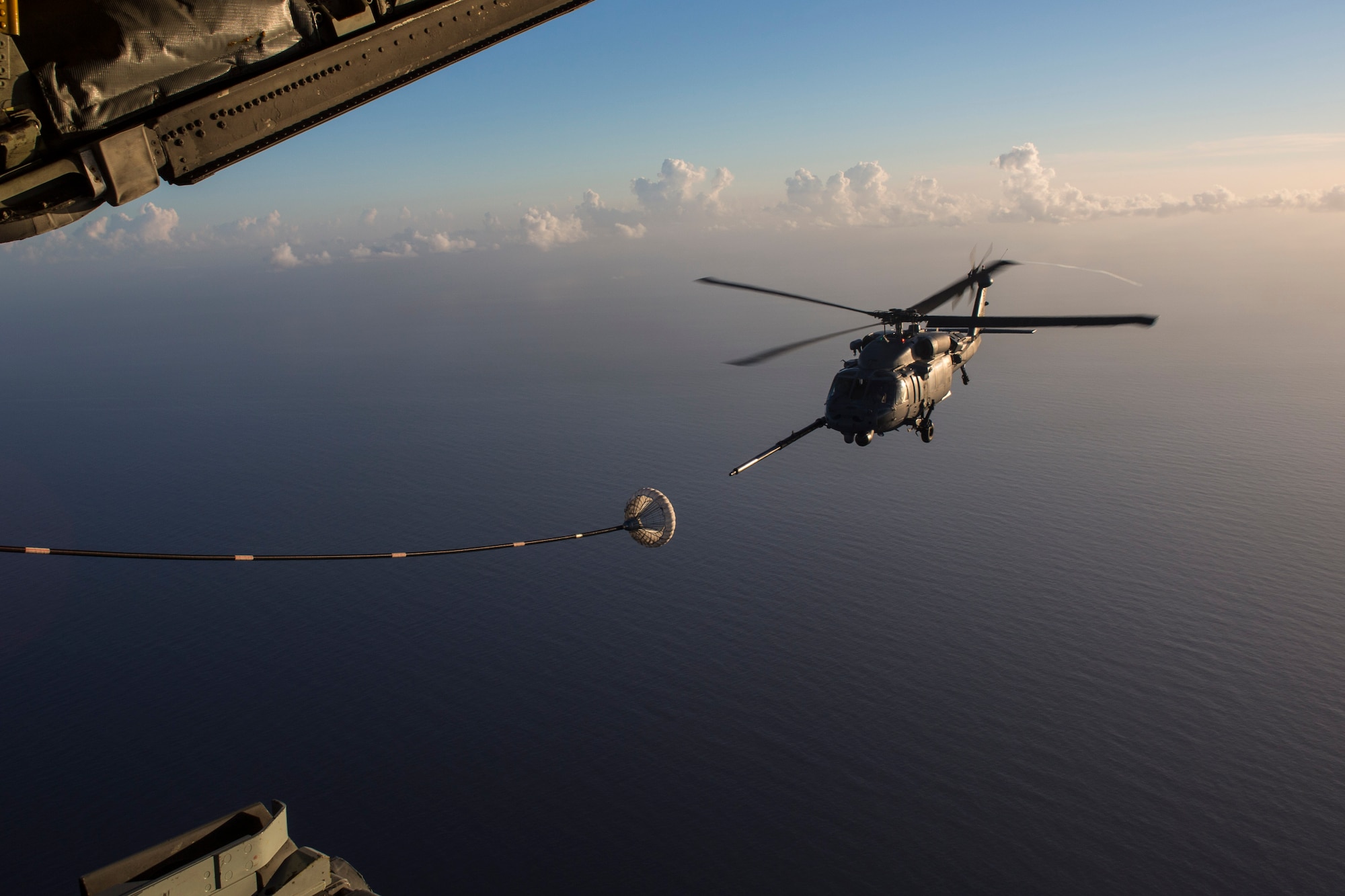 An HH-60G Pave Hawk refuels from an HC-130P/N King enroute to rescue two German citizens in distress at sea July 7, 2017 and into July 8. The victim's vessel caught fire approximately 500 nautical miles off the east coast of southern Florida. At the request of the U.S. Coast Guard's Seventh District in Miami, the 920th RQW was alerted by the Air Force Rescue Coordination Center at Tyndall Air Force Base, Florida, to assist in the long-range search and rescue. Approximately 80 wing Citizen Airmen and four wing aircraft helped execute the rescue mission to include, maintenance, operations and support personnel. (U.S. Air Force photo by Master Sgt. Mark Borosch)
