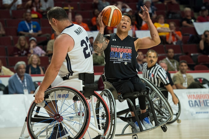 Army veteran Sgt. Jhoonar Barrera collides with Navy veteran Chief Petty Officer Hector Varela during the 2017 Department of Defense Warrior Games at the United Center in Chicago, July 7, 2017. DoD photo by EJ Hersom