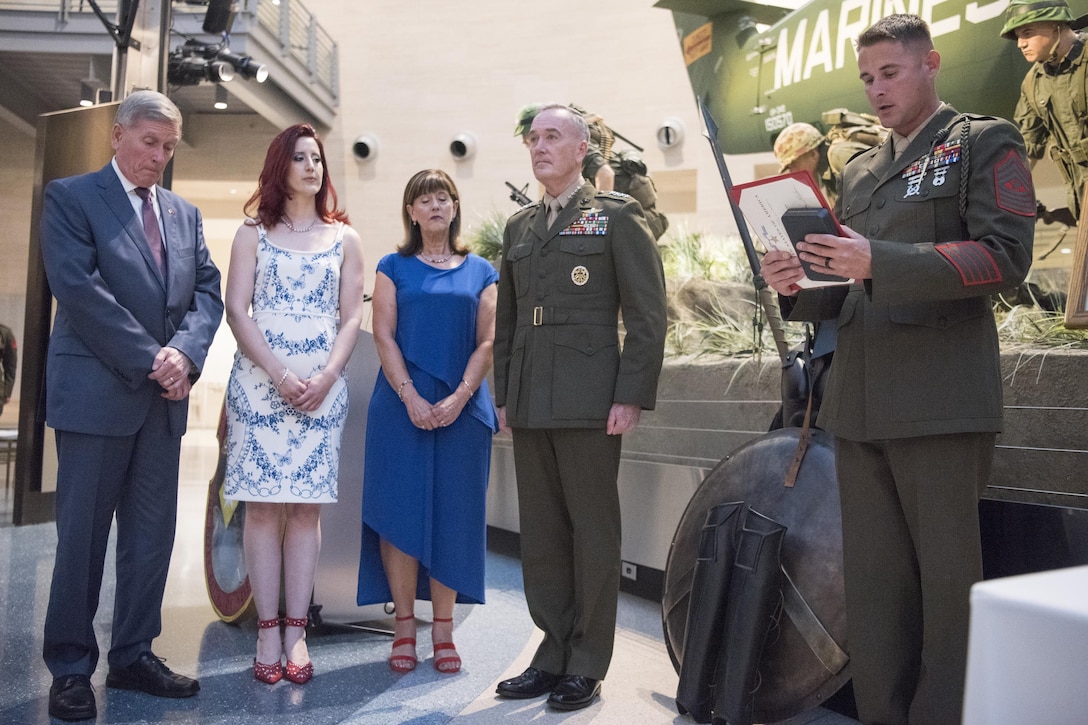 Dave Gettings, Cori Gettings, Julie Gettings, and Marine Corps Gen. Joseph F. Dunford Jr., chairman of the Joint Chiefs of Staff, listen to the Silver Star Medal Citation for Marine Cpl. Albert Gettings during the 100th Anniversary Mess Night of the 2nd Battalion, 6th Marine Regiment, at the National Marine Corps Museum in Quantica, Va., July 7, 2017. During the event, Dunford posthumously awarded the Silver Star Medal to the family of Marine Cpl. Albert Gettings, who died of wounds sustained due to enemy small-arms fire while conducting combat operations in Fallujah, Iraq in 2006. (Dept. of Defense photo by Navy Petty Officer 2nd Class Dominique A. Pineiro/Released)