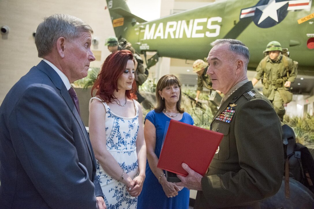 The family of Marine Cpl. Albert Gettings receive the Silver Star Medal citation from Marine Corps Gen. Joe Dunford, chairman of the Joint Chiefs of Staff, at the National Marine Corps Museum in Quantica, Va., July 7, 2017. Marine Cpl. Albert Gettings died of wounds sustained due to enemy small-arms fire while conducting combat operations in Fallujah, Iraq in 2006. Dept. of Defense photo by Navy Petty Officer 2nd Class Dominique A. Pineiro