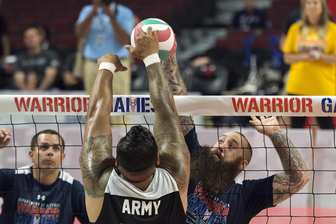Navy veteran Seaman Steven Davis attempts a spike during the sitting volleyball gold medal round of the 2017 Department of Defense Warrior Games at the United Center, Chicago, July 7, 2017. DoD photo by EJ Hersom