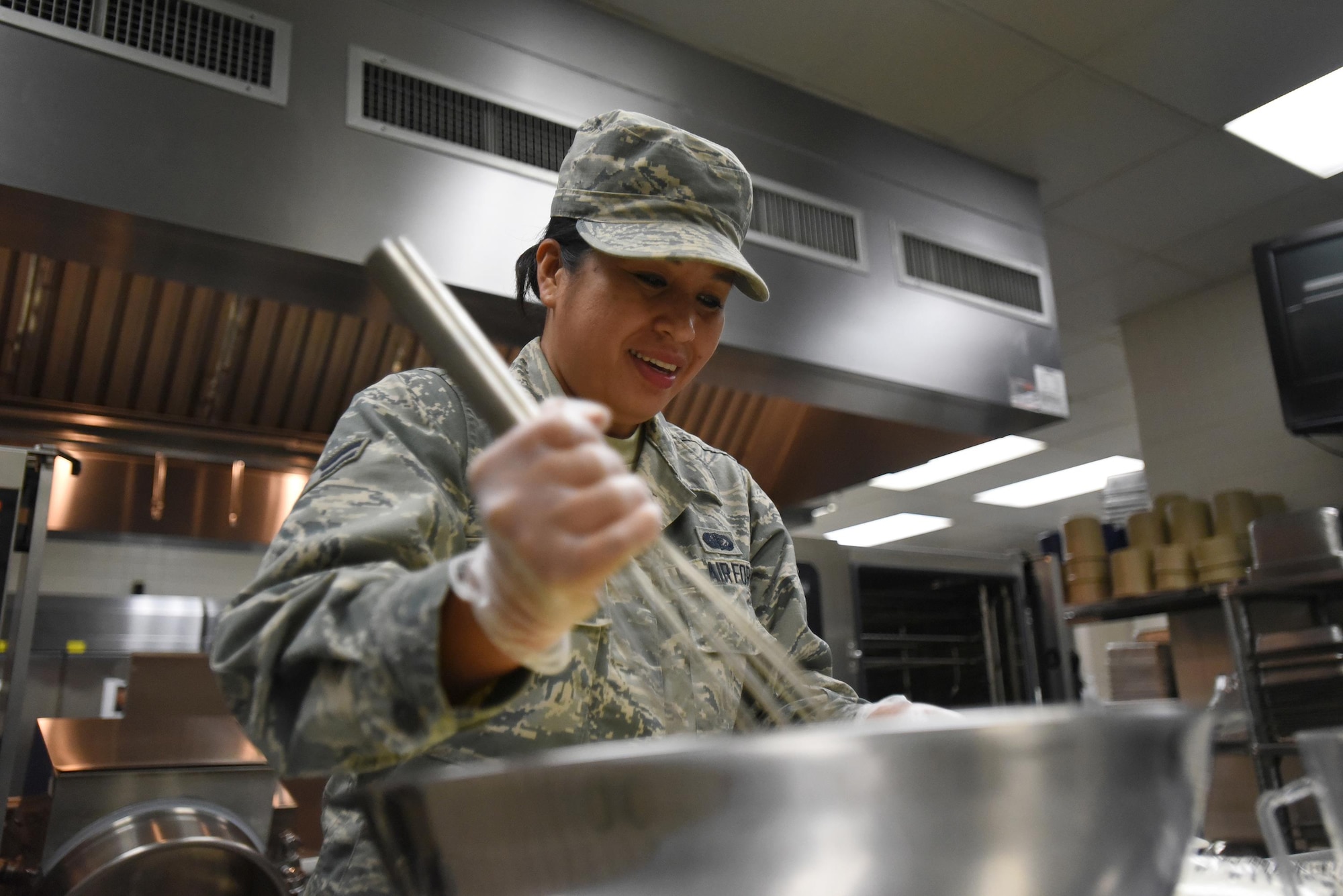 Airman 1st Class Michelle Mason, a cook for the Kentucky Air National Guard’s 123rd Services Flight in Louisville, Kentucky, stirs yellow cake batter June 6, 2017, in preparation for desserts to be served the next day in the base dining facility. Baking is done every Friday before Airman arrive for annual monthly training here. The unit recently was recognized as the best food service organization in the Air National Guard. (U.S. Air National Guard photo by Tech. Sgt. Vicky Spesard)