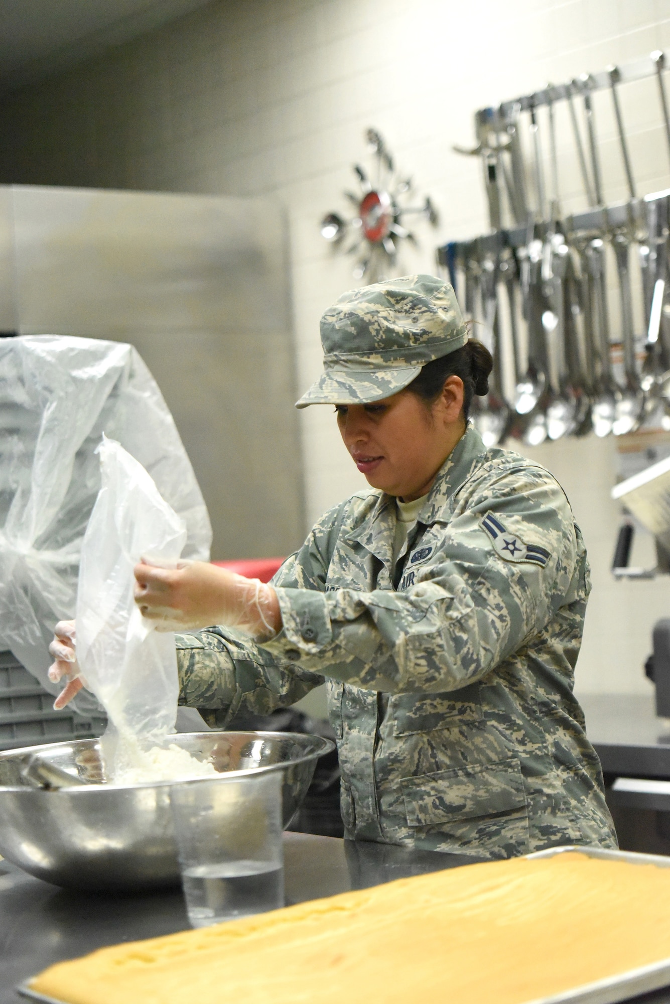 After baking a sheet cake, Airman 1st Class Michelle Mason, a cook for Kentucky Air National Guard’s 123rd Services Flight in Louisville, Kentucky, prepares the cake’s frosting June 6, 2017. Cakes, cookies and brownies are just some of the many desserts prepared in the base dining facility kitchen. The 123rd Services Flight recently was recognized as the best food service organization in the Air National Guard. (U.S. Air National Guard photo by Tech. Sgt. Vicky Spesard)