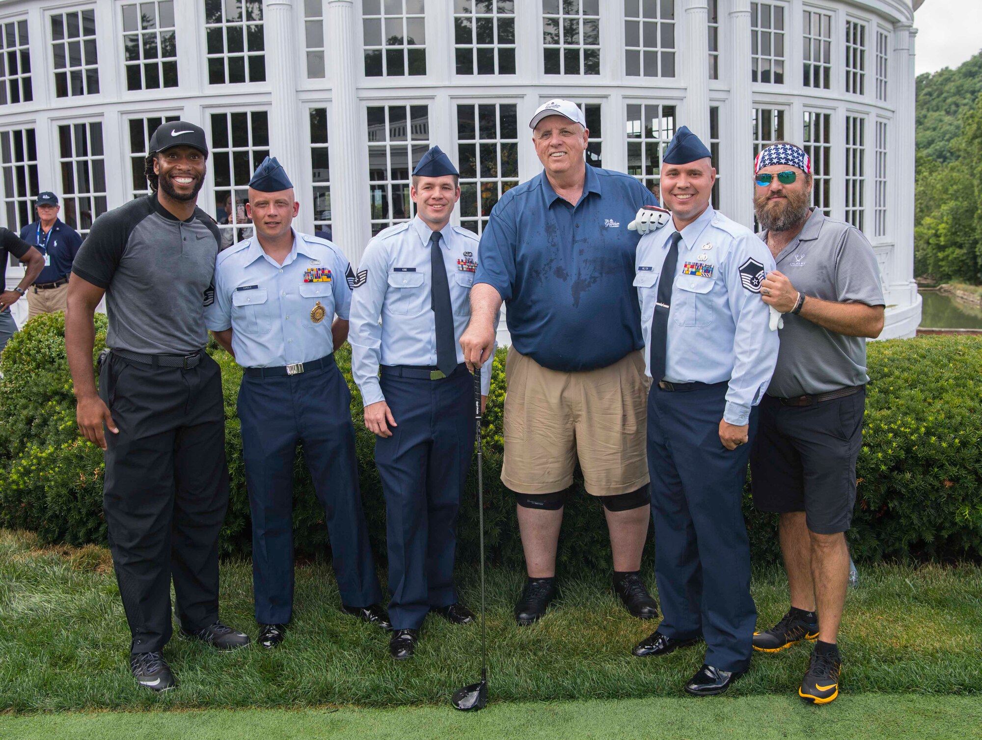 Arizona Cardinals wide receiver Larry Fitzgerald (l to r), Master Sgt. Kevin Cordle, Staff Sgt. Adam King, West Virginia Governor Jim Justice, Master Sgt. Scott Melton, and Duck Dynasty Star Willie Roberson pose for a photo prior to teeing off at the 2017 PGA Greenbrier Classic Pro Am held July 5, 2017, on The Old White TPC at The Greenbrier, White Sulphur Springs, W.Va. Cordle, King and Melton are members of the 130th Airlift Wing, McLaughlin Air National Guard Base, Charleston, W.Va. (U.S. Air National Guard photo by Tech. Sgt. De-Juan Haley) 