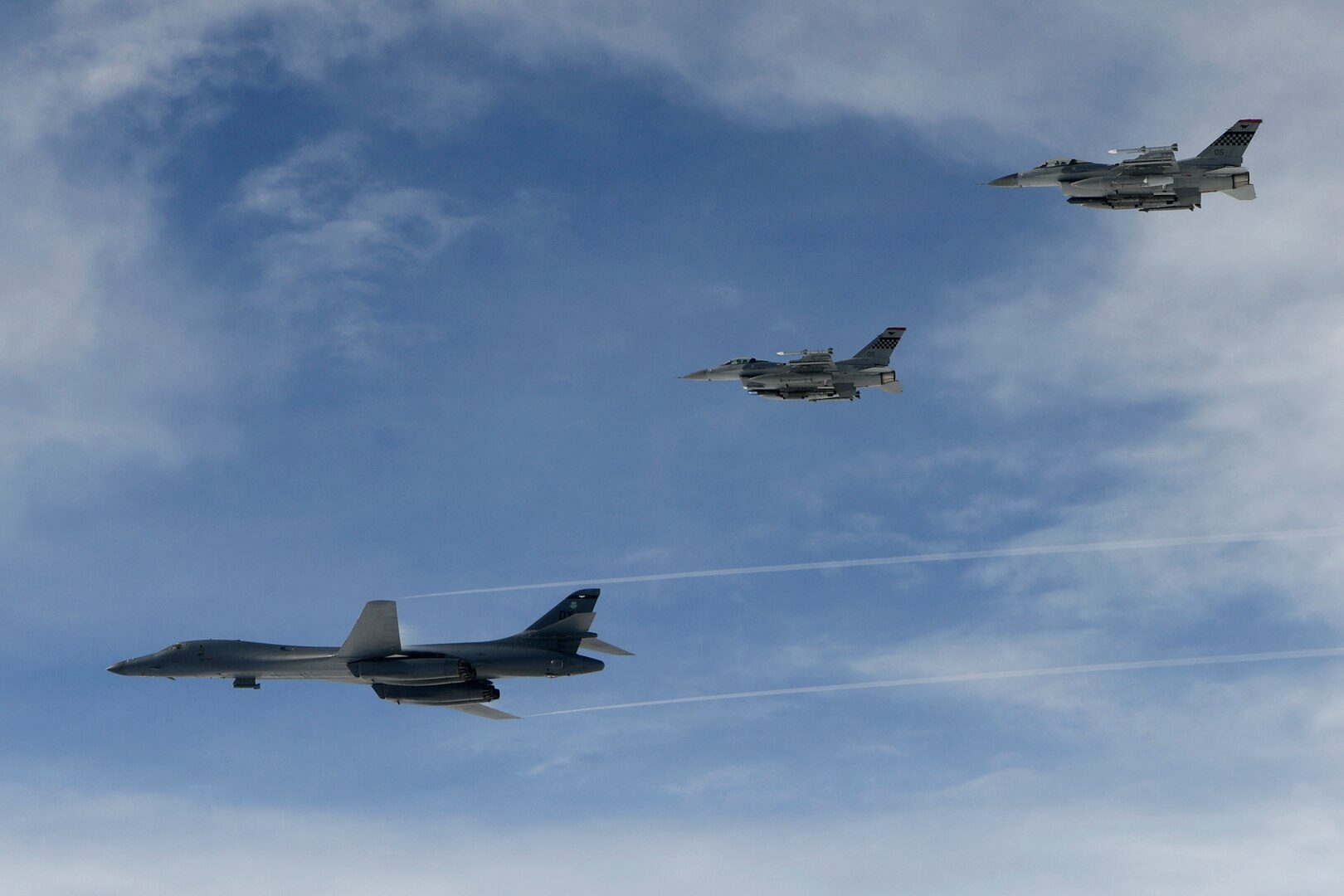 A U.S. Air Force B-1B Lancers assigned to the 9th Expeditionary Bomb Squadron, deployed from Dyess Air Force Base, Texas, fly with South Korean F-15 fighter jets over the Korean Peninsula, July 7. The Lancers departed Andersen Air Force Base, Guam to conduct sequenced bilateral missions with South Korean F-15s and U.S. Air Force F-16s then Koku Jieitai (Japan Air Self-Defense Force) F-2 fighter jets. The mission is in response to a series of increasingly escalatory action by North Korea, including a launch of an intercontinental ballistic missile (ICBM) on July 3. (photo courtesy of Republic of Korea air force)