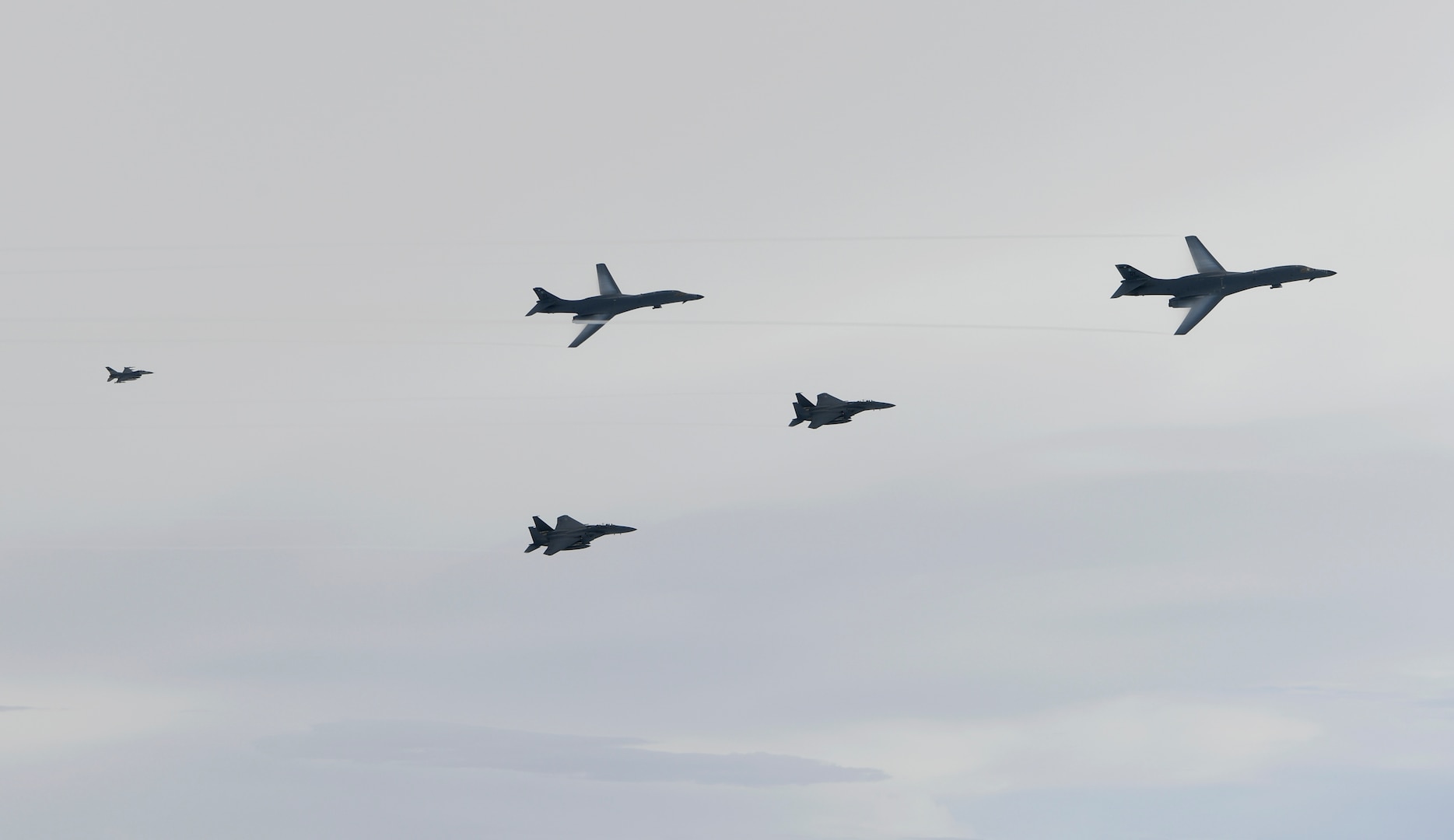 U.S. Air Force B-1B Lancers assigned to the 9th Expeditionary Bomb Squadron, deployed from Dyess Air Force Base, Texas, fly with South Korean F-15 and U.S. Air Force F-16 fighter jets over the Korean Peninsula, July 7. The Lancers departed Andersen Air Force Base, Guam to conduct a sequenced bilateral mission with South Korean F-15s and Koku Jieitai (Japan Air Self-Defense Force) F-2 fighter jets. The mission is in response to a series of increasingly escalatory action by North Korea, including a launch of an intercontinental ballistic missile (ICBM) on July 3. (photo courtesy of Republic of Korea air force)