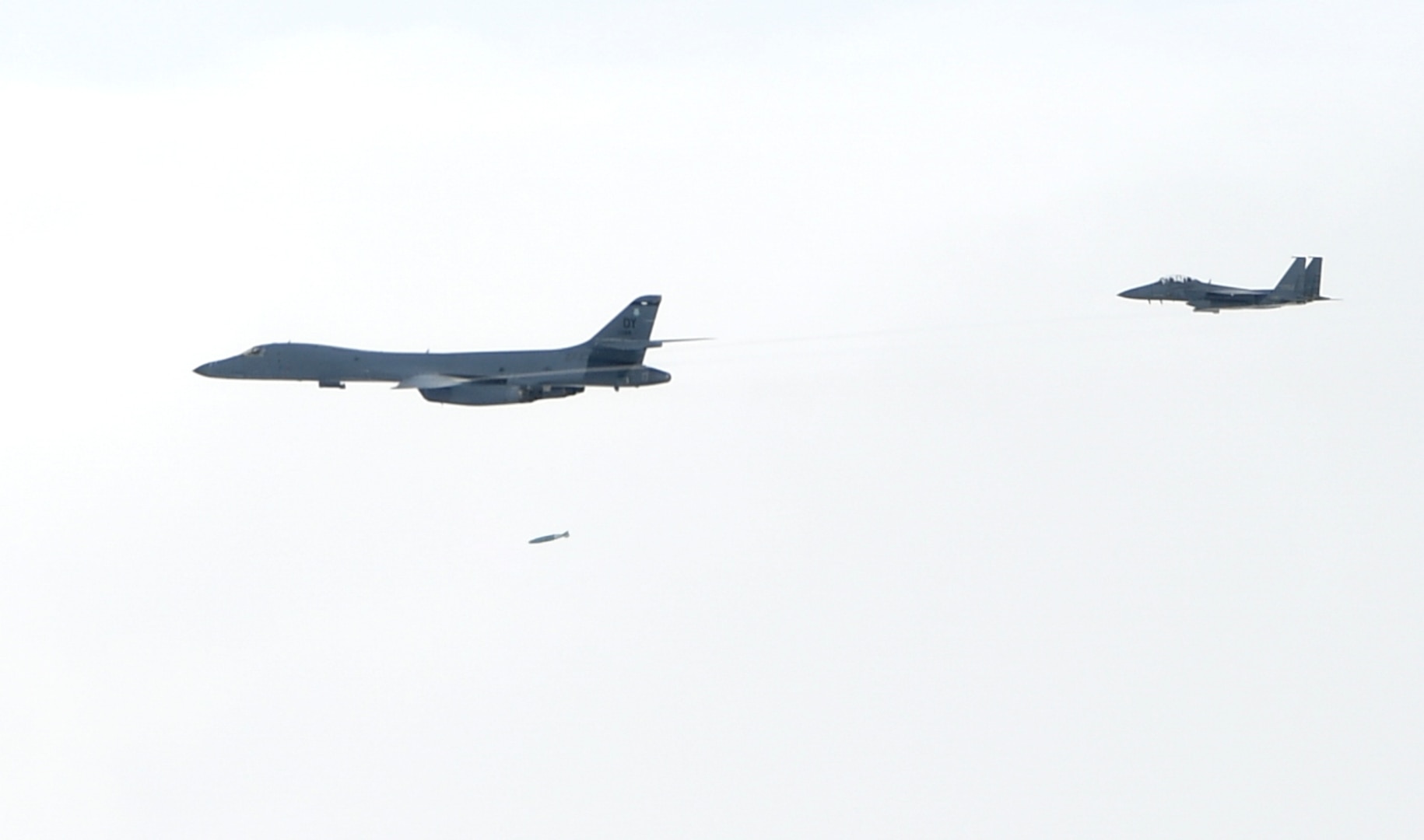 A U.S. Air Force B-1B Lancers assigned to the 9th Expeditionary Bomb Squadron, deployed from Dyess Air Force Base, Texas, fly with a South Korean F-15 fighter jet over the Korean Peninsula, July 7. The Lancers departed Andersen Air Force Base, Guam to conduct a sequenced bilateral mission with South Korean F-15s and Koku Jieitai (Japan Air Self-Defense Force) F-2 fighter jets. The mission is in response to a series of increasingly escalatory action by North Korea, including a launch of an intercontinental ballistic missile (ICBM) on July 3. (photo courtesy of Republic of Korea air force)