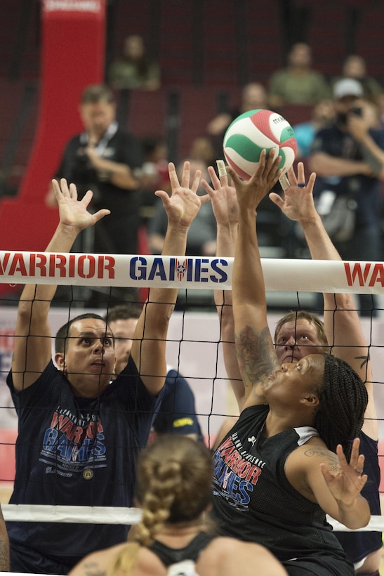 Army Spc. Stepahine Morris tips a ball over the net during the sitting volleyball gold medal round of the 2017 Dept. of Defense Warrior Games at the United Center in Chicago July 7, 2017. (DoD photo by EJ Hersom)