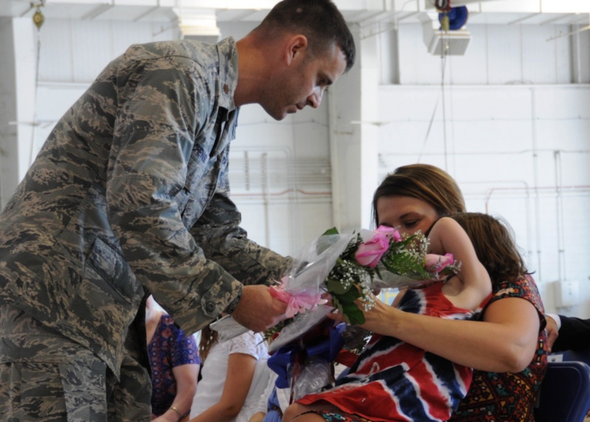 Maj. James Chevalier, the new 442d Aircraft Maintenance Squadron commander, presents flowers to his family members during his assumption of command ceremony at Whiteman Air Force Base, Mo., July 8, 2017. Chevalier graduated from the University of Central Missouri with a Masters of Aviation Safety in 2004 and two years later was selected to commission under the Deserving Airman Program. (U.S. Air Force photo by Senior Airman Missy Sterling)