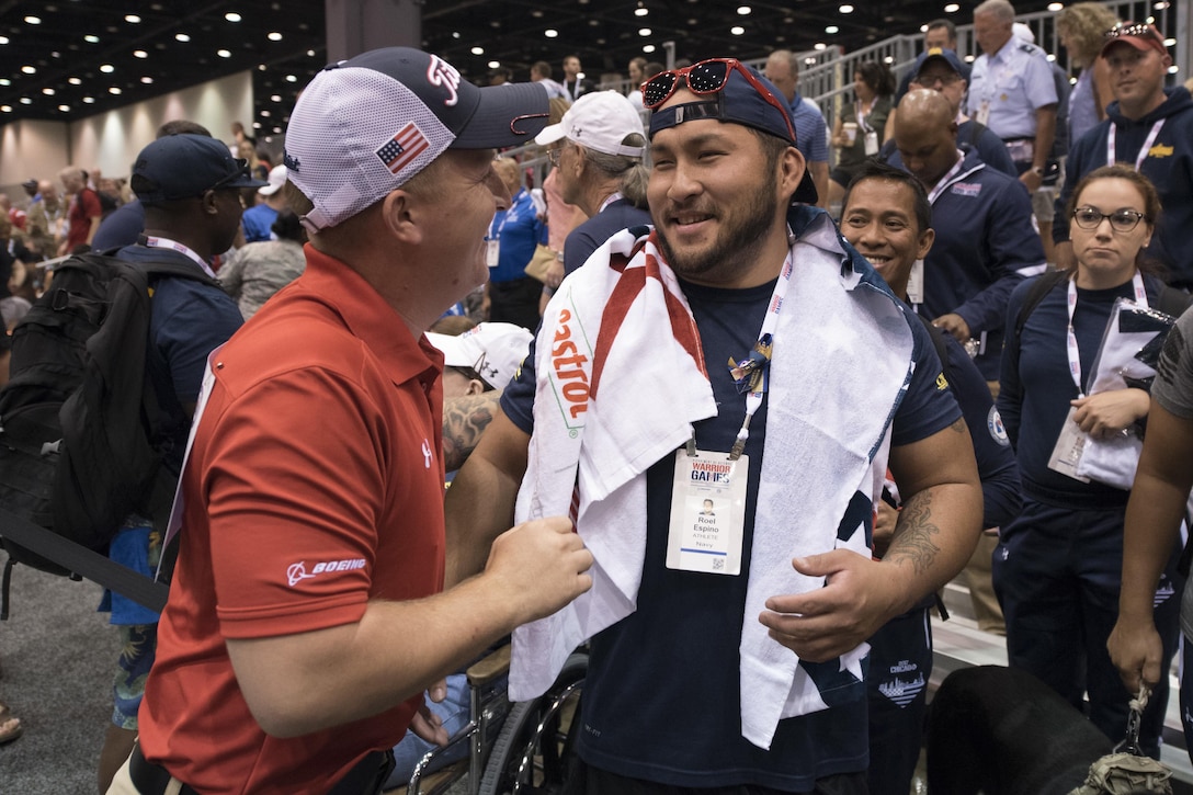 Marine Corps Sgt. Jacob H. Greenlief, left, is congratulated by Navy veteran Roel Espino after Greenlief won a gold medal in air pistol finals during the 2017 Department of Defense Warrior Games in Chicago, July 6, 2017. DoD photo by Roger L. Wollenberg